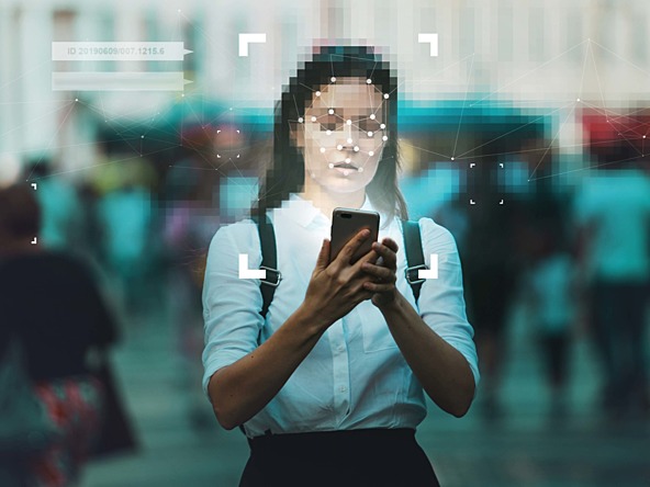 photo of woman on her smart phone having her face scanned